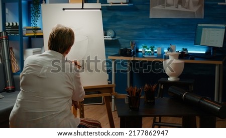 Senior artist drawing professional sketch with creative skills, using artistic tools and equipment to draw vase design. Working on artwork masterpiece for art and craft hobby, home workshop. Royalty-Free Stock Photo #2177862947