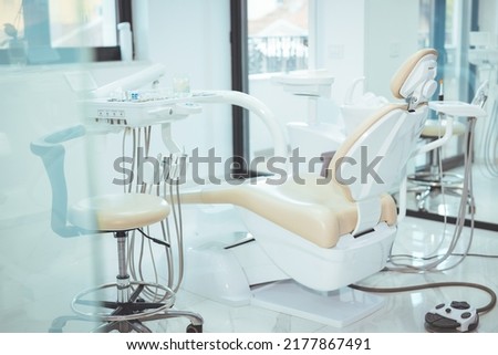 Modern dental practice. Dental chair and other accessories used by dentists. Dentist Office, Dental Hygiene, Dentist's Chair. dentistry, medicine, medical equipment and stomatology concept 