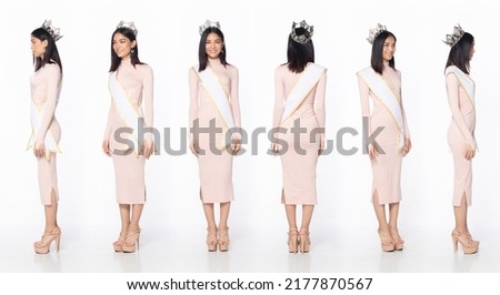 Full length of Miss Beauty Pageant Contest wear pastel pink evening sequin gown with diamond crown sash, Asian female stand express feeling happy smile over white background isolated Royalty-Free Stock Photo #2177870567