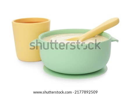 Healthy baby food in bowl and drink on white background Royalty-Free Stock Photo #2177892509