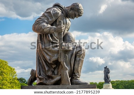 Red Army soldier paying respect in Tretptower soviet war memorial, Berlin Germany