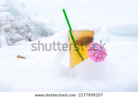 Glass of Ice Tea on Frozen Snow and Ice 