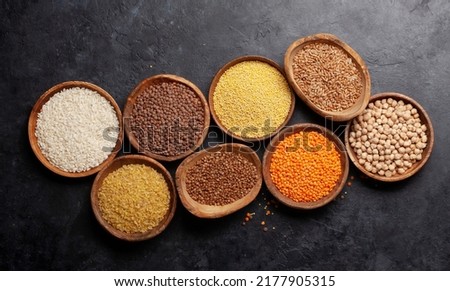 Gluten free cereals. Rice, buckwheat, corn groats, quinoa and millet in wooden bowls. Top view flat lay Royalty-Free Stock Photo #2177905315