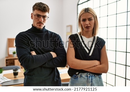 Two beautiful business workers wearing business style standing at the office skeptic and nervous, disapproving expression on face with crossed arms. negative person.  Royalty-Free Stock Photo #2177921125