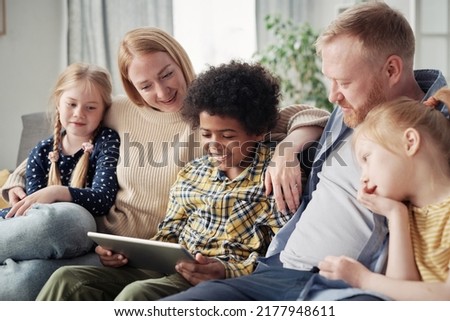 Happy children with foster parents at home