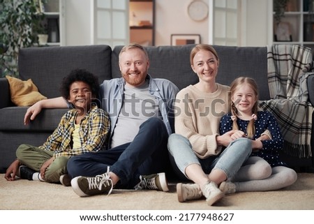 Happy family with adopted children at home
