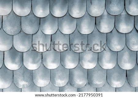 Close-up detail metallic texture pattern matte medieval replica steel chain mail scales plates knight armor. Old ancient iron metal body armour protection. Abstract chainmale dragon skin background Royalty-Free Stock Photo #2177950391