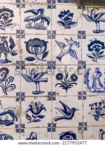 Blue and white tile pattern with flower and bird motifs on old fountain, Viana do Castelo, Portugal.