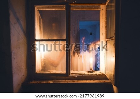 Ghost in abandoned, haunted house. Horror scene of scary spirit of a woman, halloween concept.