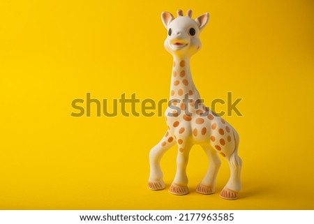 Giraffe teeth toy on yellow background
