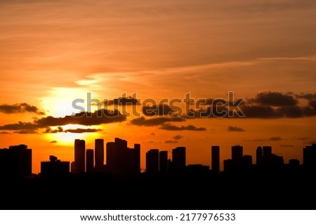 front view, far distance of, buildings in silhouette, of the Miami, Florida skyline at dawn 