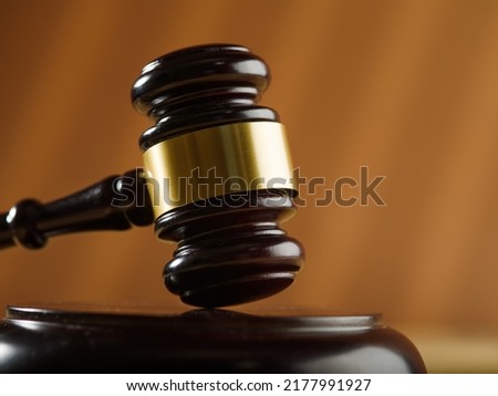 Close-up. Wooden judge's gavel on a beige background. Court, justice, presumption of innocence, Constitution, rule of law, auction. Banner, poster. There is no one in the photo. Royalty-Free Stock Photo #2177991927