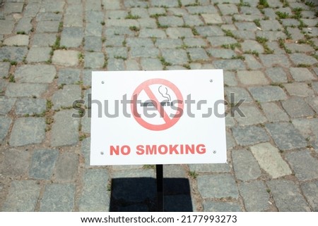 No smoking and smoking area signs are set.