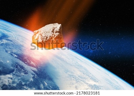 Planet Earth and big asteroid in the space. Potentially hazardous asteroids. Asteroid in outer space near Earth planet. Elements of this image furnished by NASA. Royalty-Free Stock Photo #2178023181