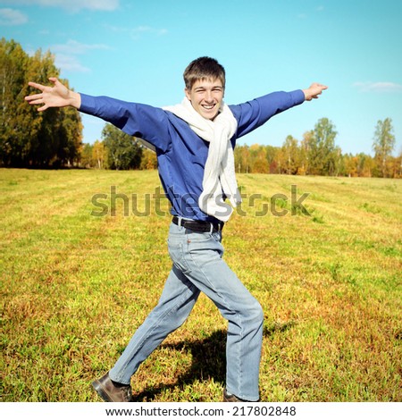 Toned photo of Happy Teenager running on the Autumn Field