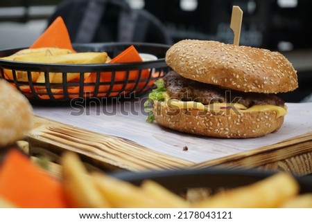 Beef burger with blur shade of fries 