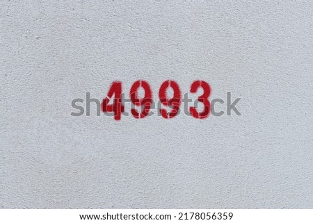 Red Number 4993 on the white wall. Spray paint.
