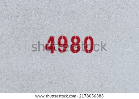 Red Number 4980 on the white wall. Spray paint.
