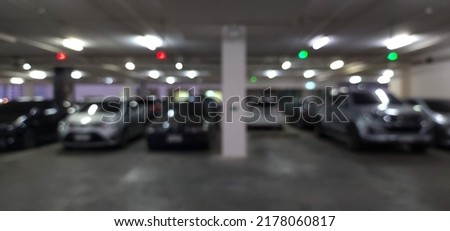 blur indoor parking lot cars full in supermarket for background with dark tone