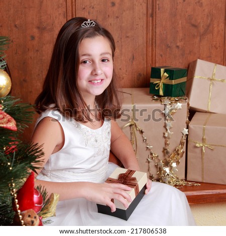 Happy smiley little girl over christmas decoration on Holiday theme/Happy little girl with Christmas gifts 