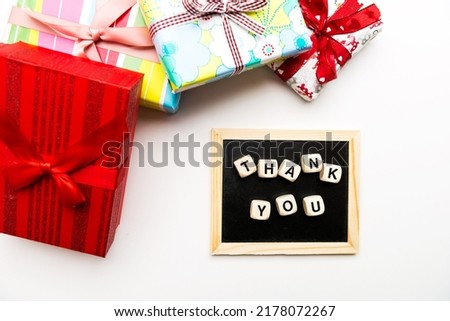 gifts in colorful boxes with ribbons and an inscription from THANKS cubes. View from above.