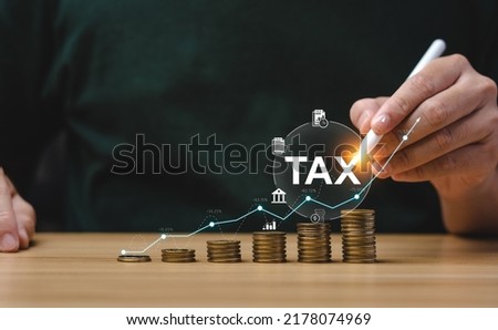 Tax deduction planning concept. Expenses, account, VAT, income tax, and property tax, pay tax. Businessman's hand and pile of coins on the table. Royalty-Free Stock Photo #2178074969