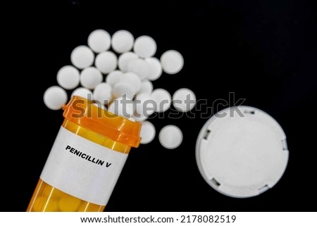 Penicillin V Rx medical pills in plactic Bottle with tablets. Pills spilling out from yellow container. Royalty-Free Stock Photo #2178082519