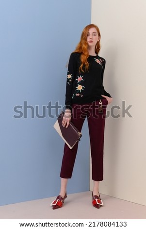 portrait of
fashion model Posed on beige and blue background in fashion clothes 

