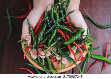 Cabai merah dan hijau or red and green chilies on a wooden table background Photo taken in the studio