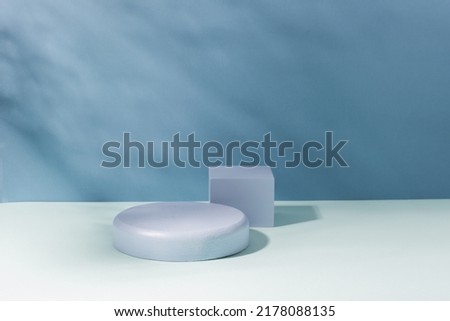 Abstract creative pedestal podium, blue hard shadow background. Minimalism, product showcase, copy space
