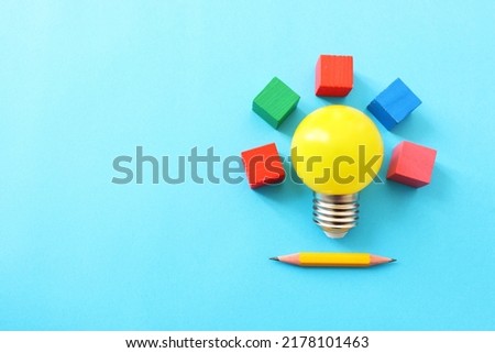Education concept image. Creative idea and innovation. yellow light bulb over blue background