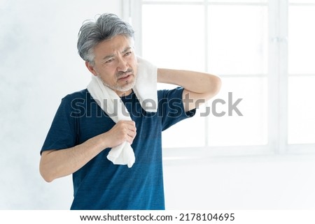 Asian sporty senior man in the room Royalty-Free Stock Photo #2178104695