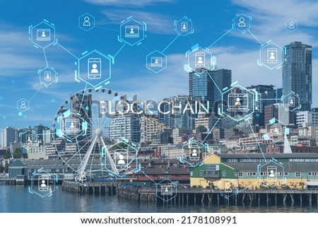 Seattle skyline with waterfront view. Skyscrapers of financial downtown at day time, Washington, USA. Decentralized economy. Blockchain, cryptography and cryptocurrency concept, hologram