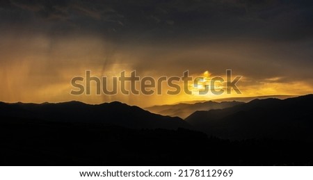 Beautiful landscape in the mountains at sunset. View of colorful sky with amazing clouds. Scenic View Of Silhouette Mountain Against Sky At Sunset Royalty-Free Stock Photo #2178112969