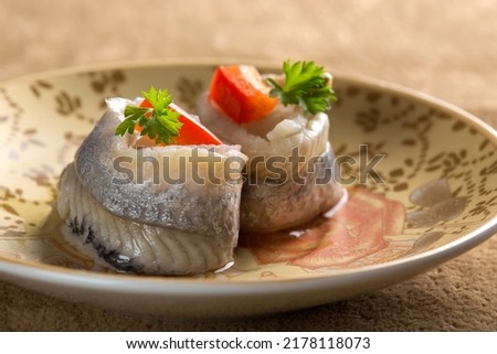 Pickled rollmops herrings with parsley and red bell pepper Royalty-Free Stock Photo #2178118073