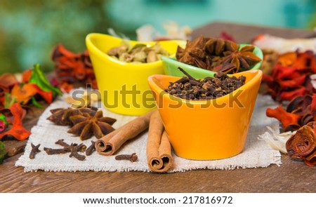 Different spices on hessian cloth napkin. Cinnamon sticks, carnation, star anise, cardamom. Shallow depth of field