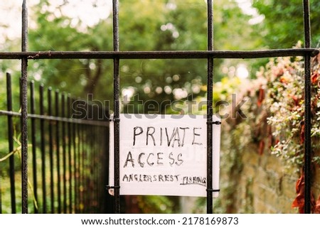 Ad hoc Private Access Sign seen attached to a wrought iron gate for access to a private fishing club.