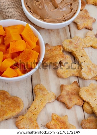 homemade organic dog biscuit treats and ingredients on raw wood with copy space Royalty-Free Stock Photo #2178172149