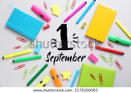 Bright school supplies and text 1 SEPTEMBER on light background Royalty-Free Stock Photo #2178200083