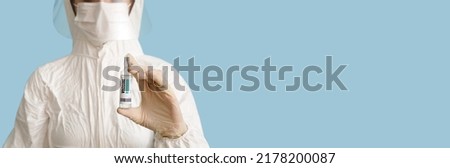 Scientist holding monkeypox vaccine on blue background with space for text
