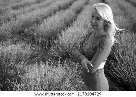 beautiful girl in a green dress in nature, green thuja, summer, black and white photo