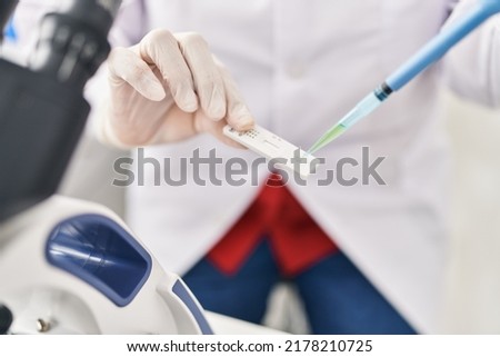 Middle age hispanic woman using antigen test at laboratory