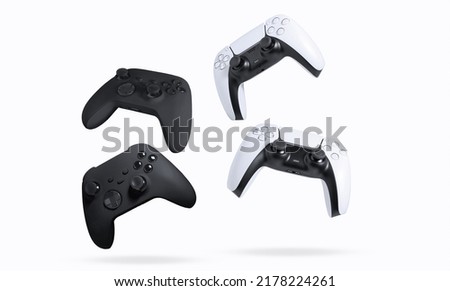 Black and white game controllers on white background Royalty-Free Stock Photo #2178224261