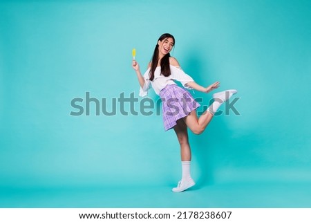 Full body photo of college student learning weekends hold cold dessert popsicle wear long socks isolated cyan color background