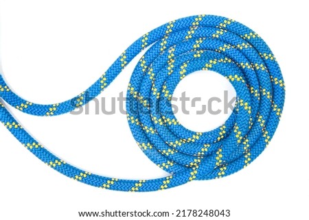 durable colored rope for climbing equipment on a white background. coil of braided cable. item for tourism and travel Royalty-Free Stock Photo #2178248043