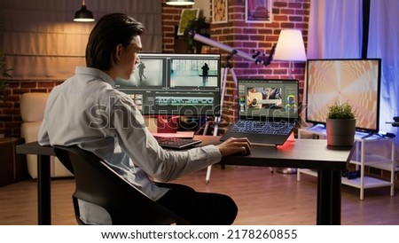 Male videographer editing footage with visual effects software, creating content and designing video montage with color gradient. Multimedia film production on computer. .
