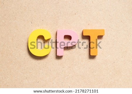Color alphabet letter in word CPT (Abbreviation of Carriage Paid To) on wood background
