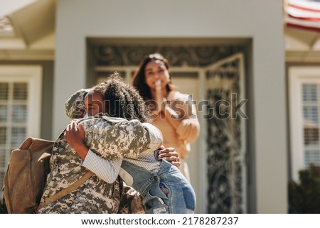 Military man saying goodbye to his family before leaving for war. American serviceman embracing his daughter. Patriotic soldier leaving his family to go serve his country in the army. Royalty-Free Stock Photo #2178287237