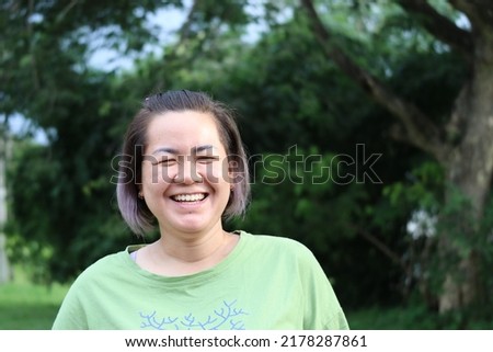 Asian woman portrait 40 years old short hair with bright face outdoor
