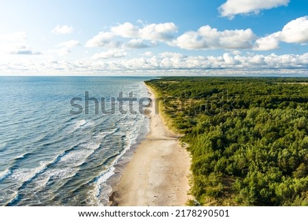 Aerial view of the Baltic Sea shore line near Klaipeda city, Lithuania. Beautiful sea coast on sunny summer day. Royalty-Free Stock Photo #2178290501